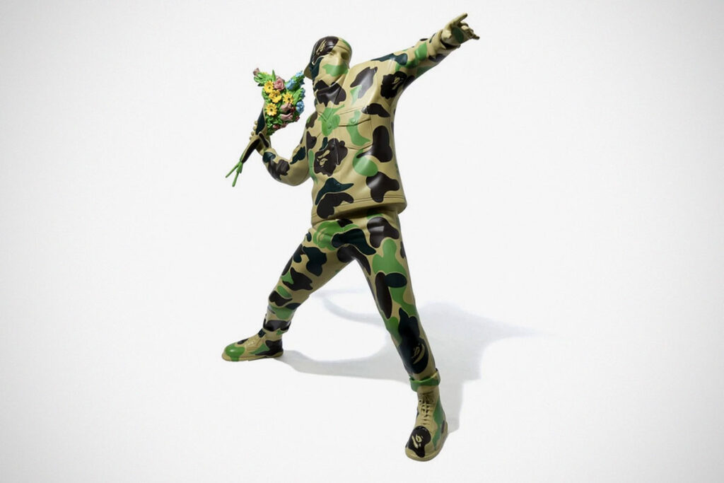 Banksy's Famous Flower Bomber Into A Vinyl Figure Again, This Time By BAPE -