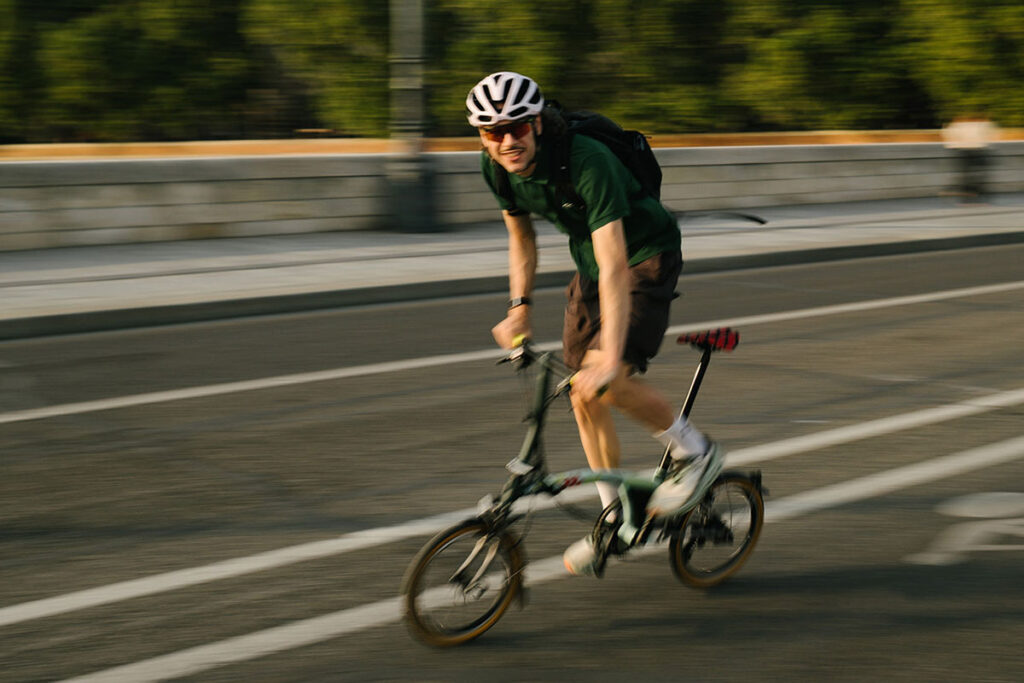 Brompton Tour de France P Line trifold bike in Sprinters Light Green with raw titanium frame and Tour graphics