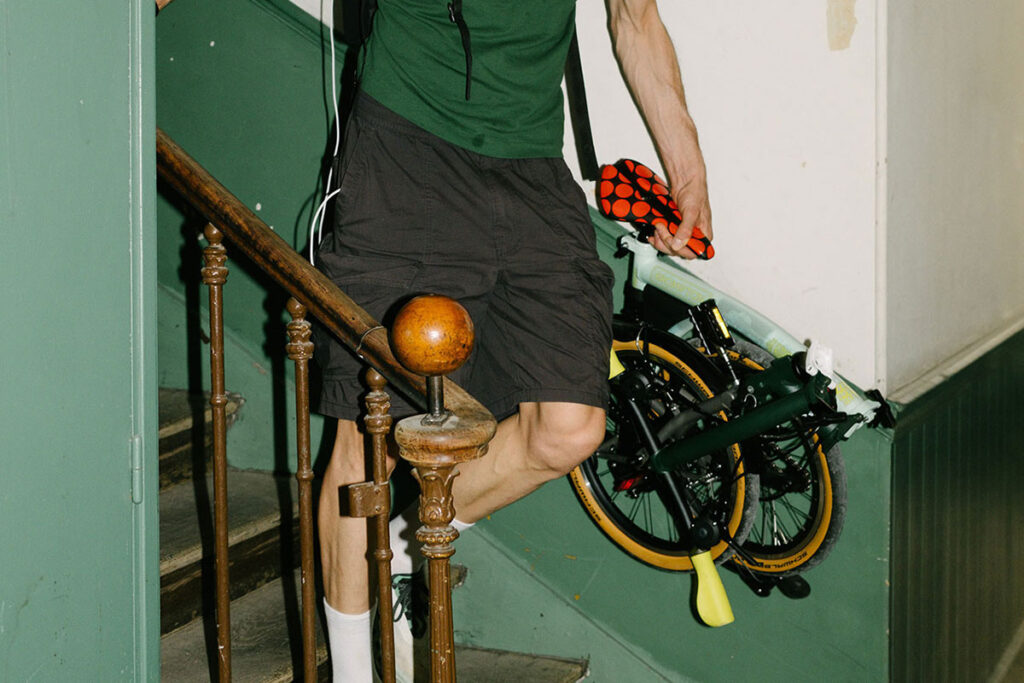 Brompton Tour de France P Line trifold bike in Sprinters Light Green with raw titanium frame and Tour graphics