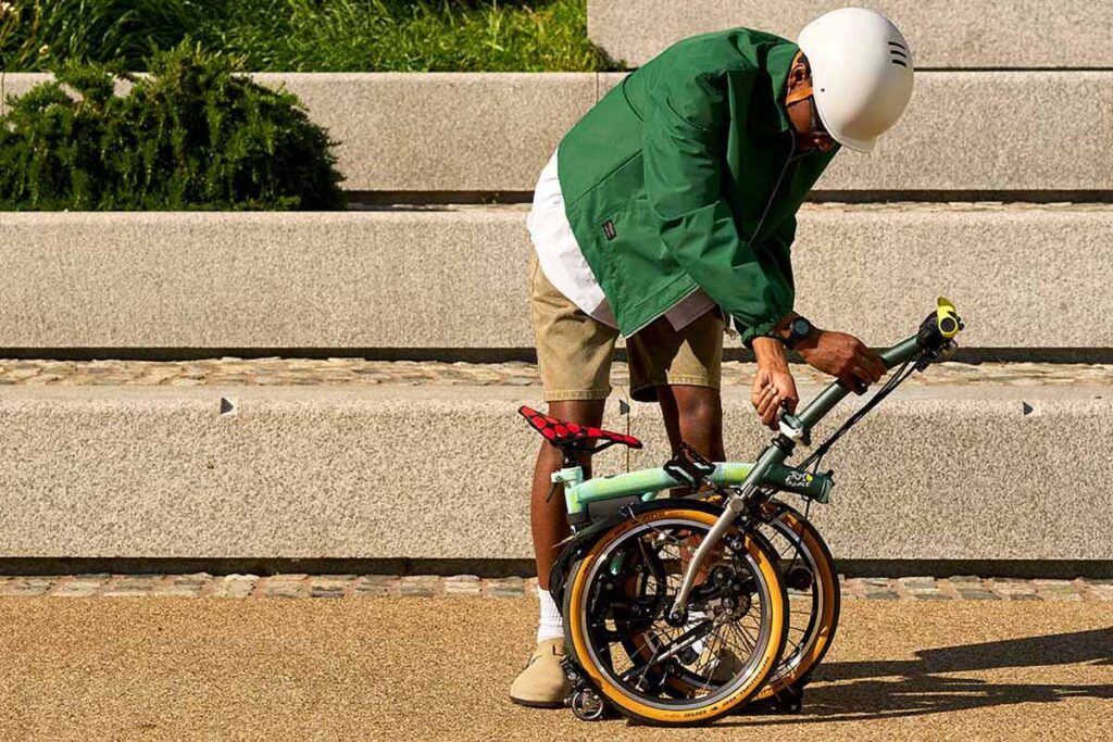 Brompton Tour de France P Line trifold bike in Sprinters Light Green with raw titanium frame and Tour graphics