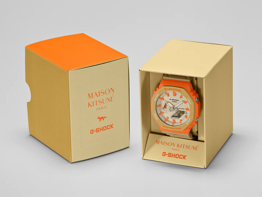 G-Shock Maison Kitsuné GA2110MK-5A collaboration watch with orange bezel and neutral Paris-inspired colorway