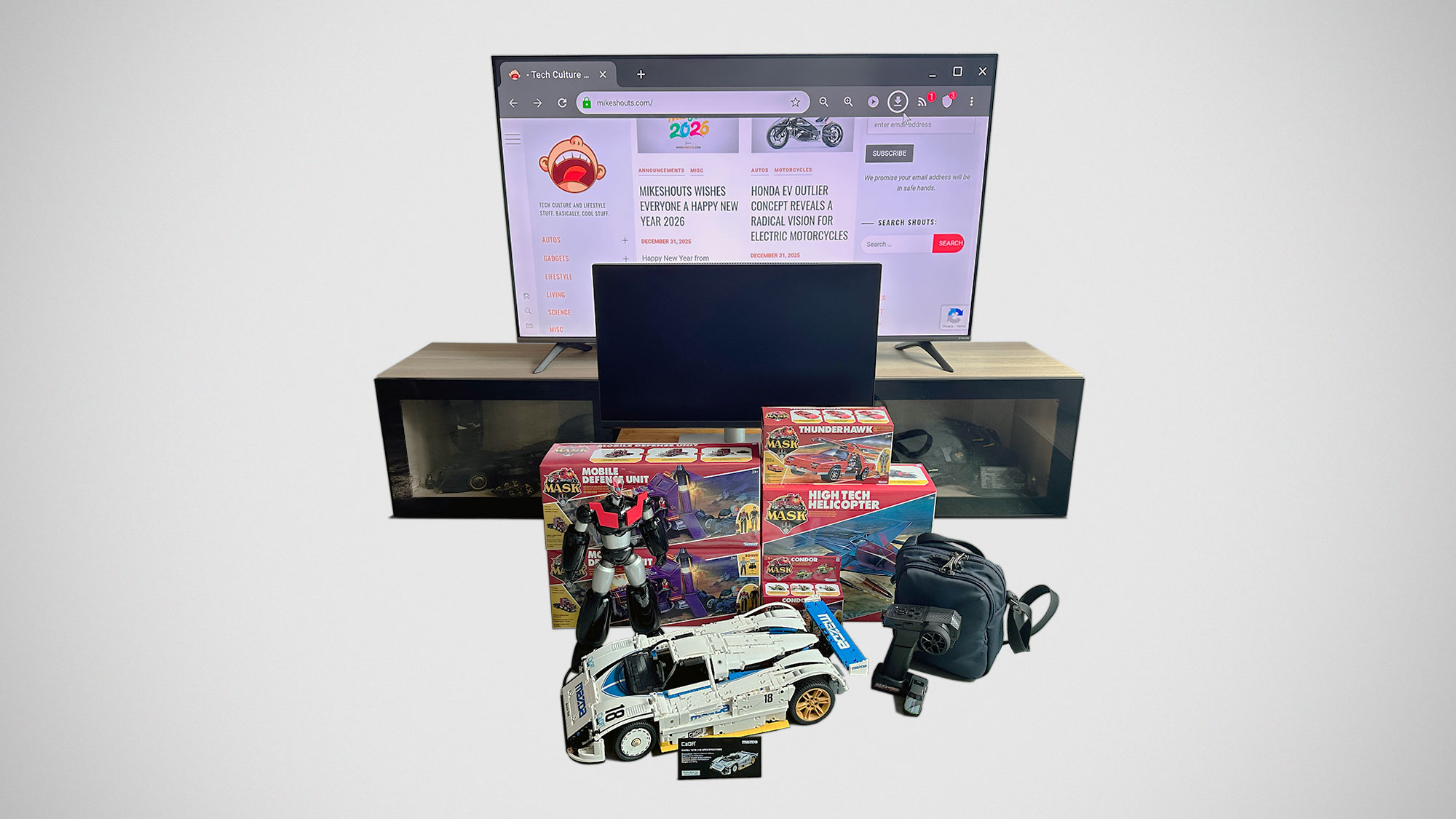 A curated selection of gadgets and toys bought in 2025, including a brick-built race car model, RC toy, Mini LED TV, and collectible figures