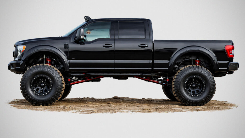 Pickup truck running larger tires with suspension modifications on rugged terrain