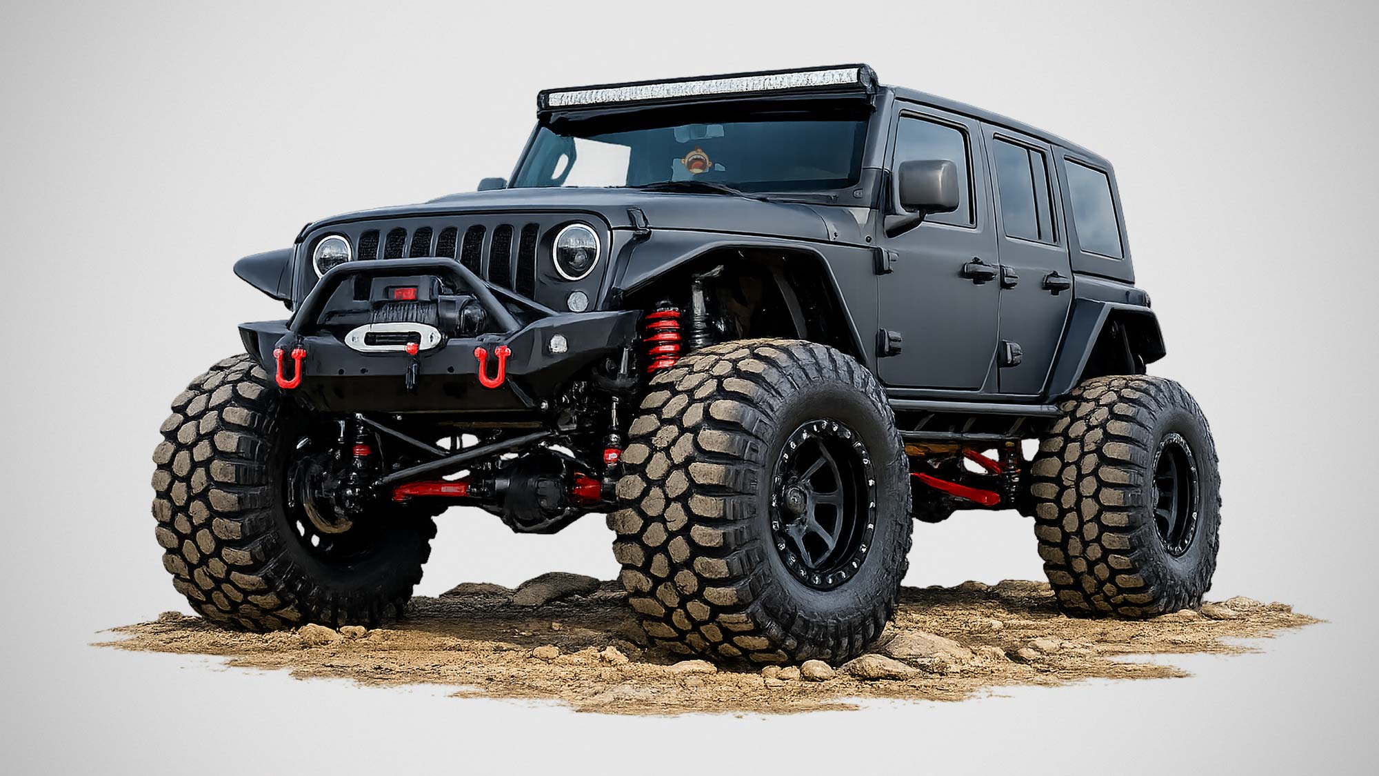 Off-road vehicle running larger tires with suspension modifications on rugged terrain